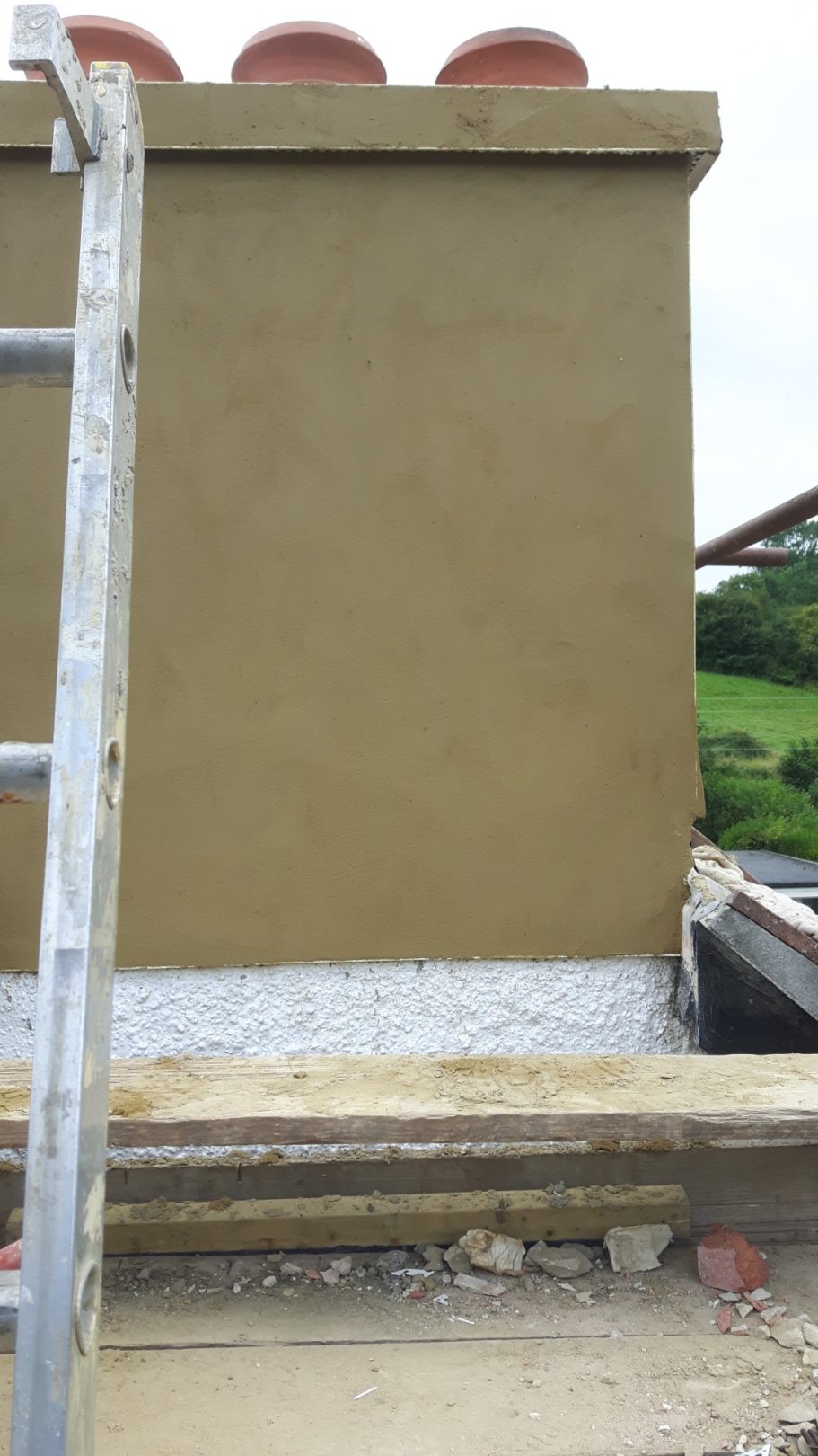 The chimney is repaired and rendered, ready for painting. The chimney is repaired and rendered, ready for painting.