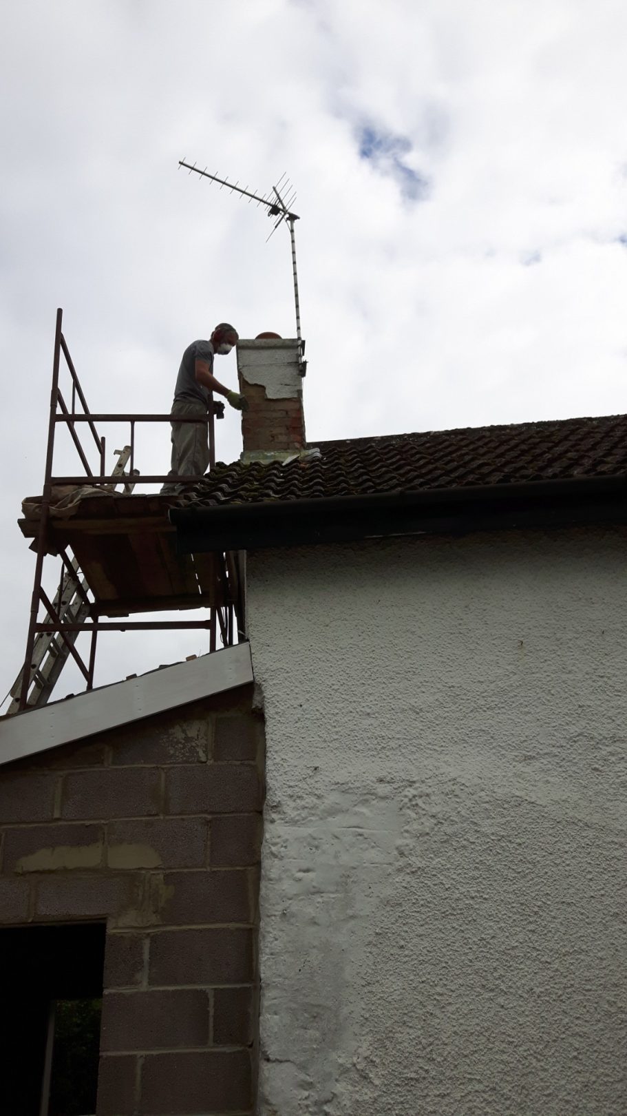 Colin removes the old render from the chimney. Colin removes the old render from the chimney.
