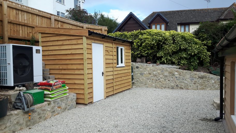 A new shed was built in place of the old concrete garage. The block wall is clad in flint. A new shed was built in place of the old concrete garage. The block wall is clad in flint.