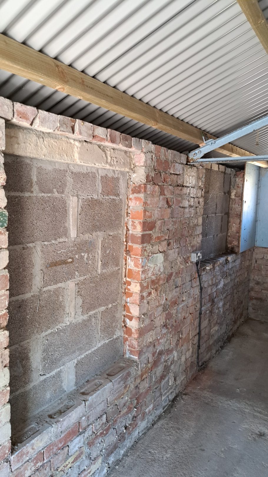 Garage windows were bricked up and a new metal roof fitted. Garage windows were bricked up and a new metal roof fitted.