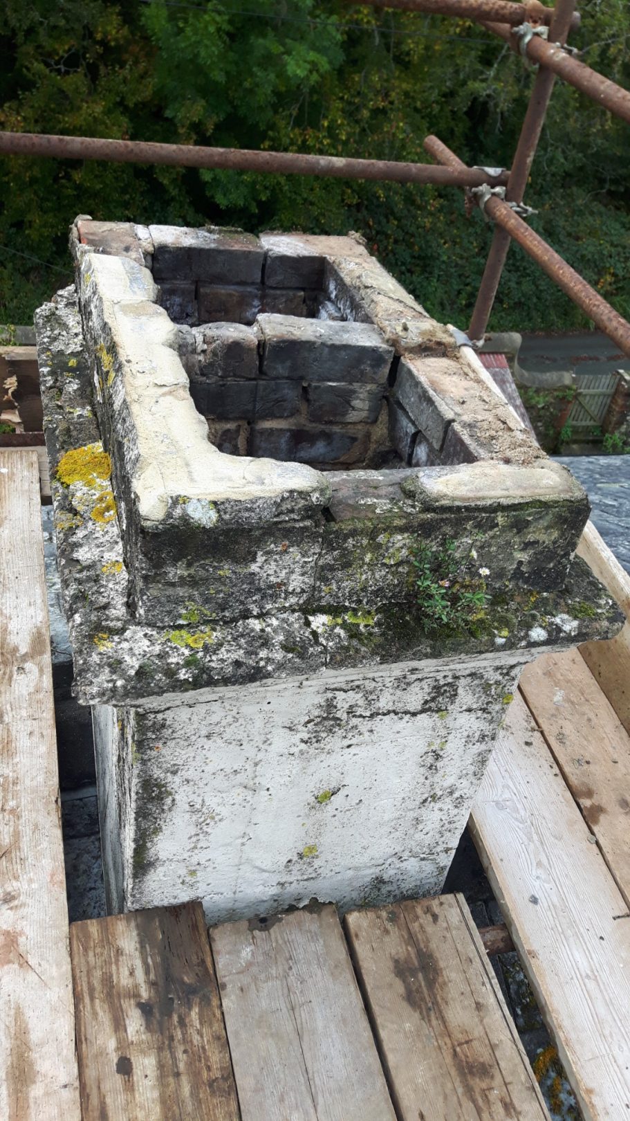 The top of the chimney to be removed and rebuilt. A liner is added. The top of the chimney to be removed and rebuilt. A liner is added.