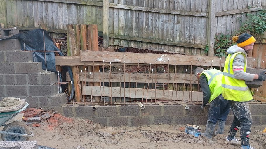 We retained the timber retaining wall and reinforced it with scaffold planks, this was all removed later. We retained the timber retaining wall and reinforced it with scaffold planks, this was all removed later.