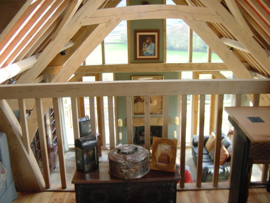 View of the mezzanine banister and oak flooring. View of the mezzanine banister and oak flooring.